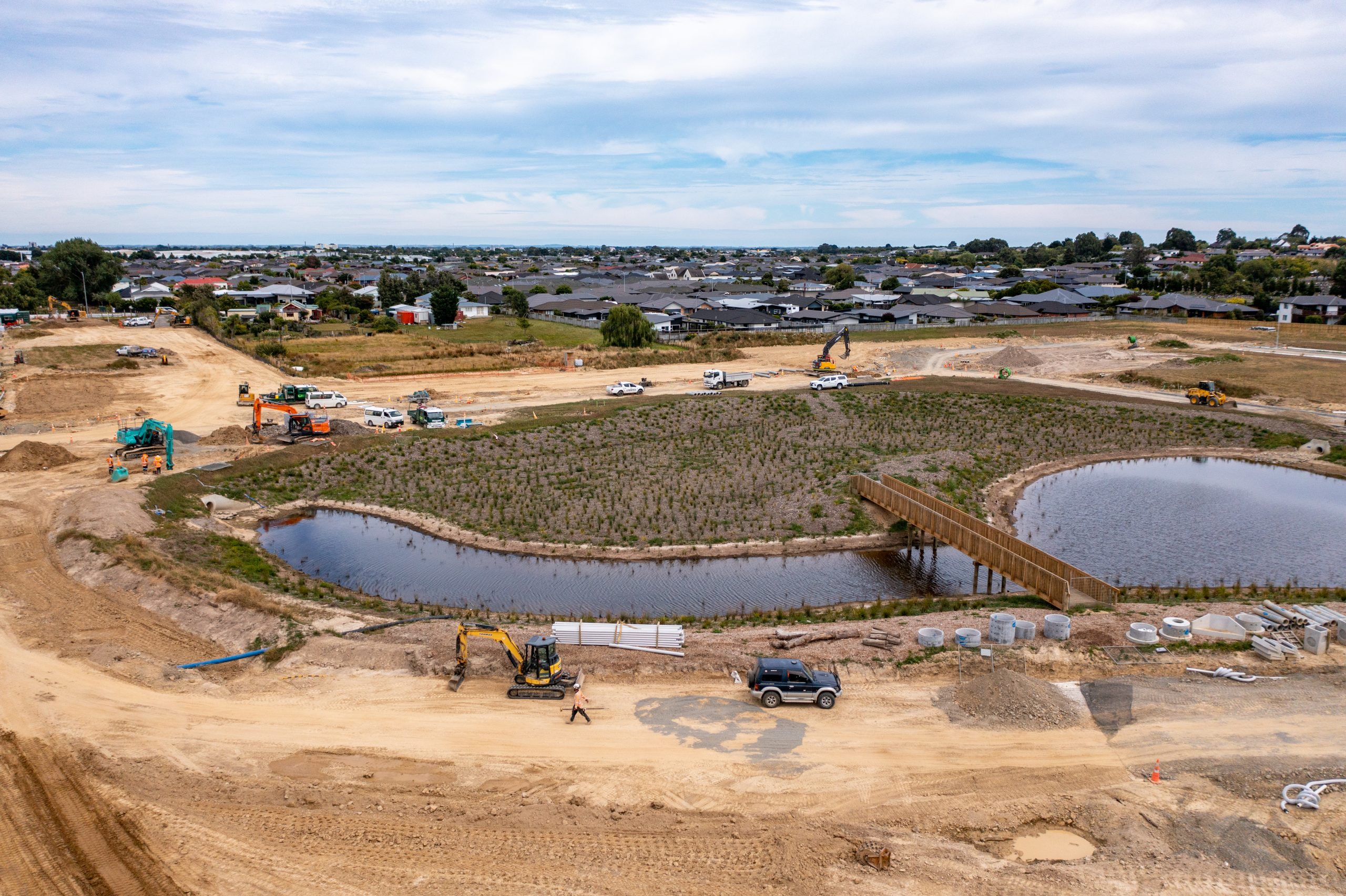 Construction landscape and equipment near a pond