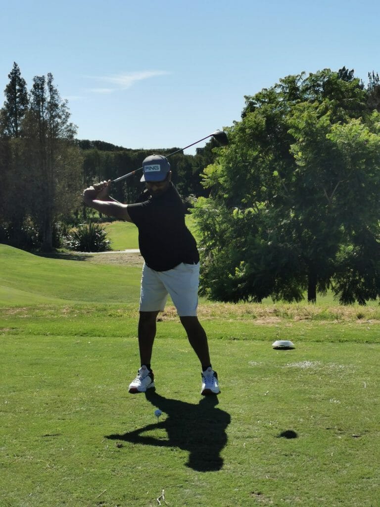 a person swinging a golf club