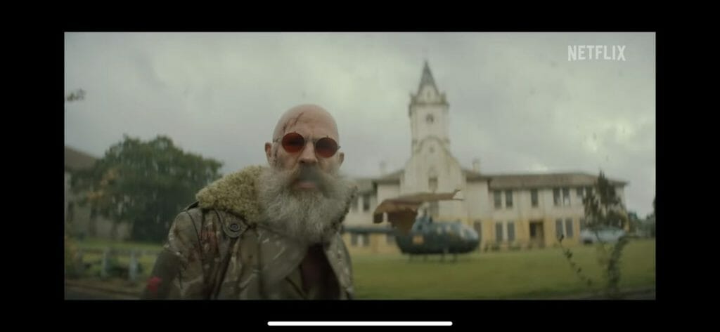 a bearded and man in front of old building