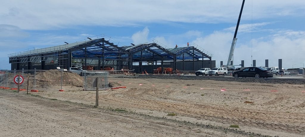 A commercial building under construction with blue sky